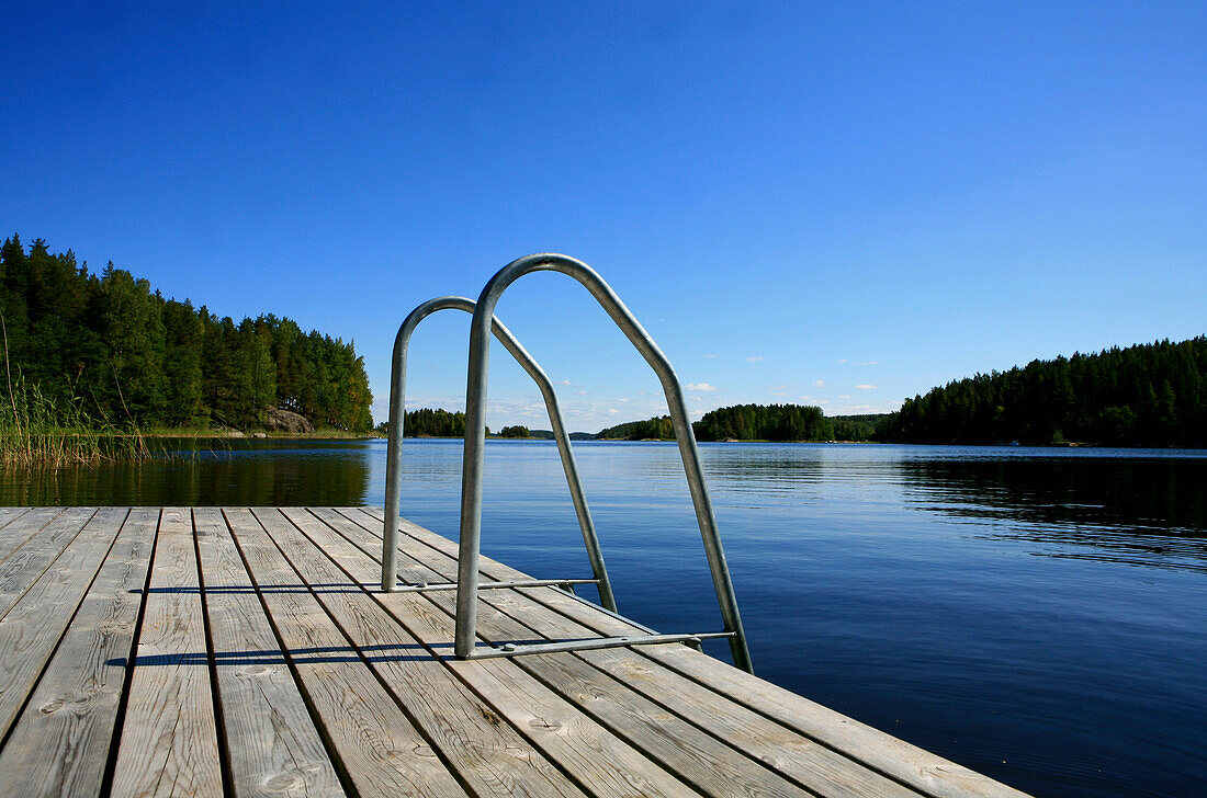 Private jetty in a bay under blue sky, Saimaa Lake District, Finland, Europe