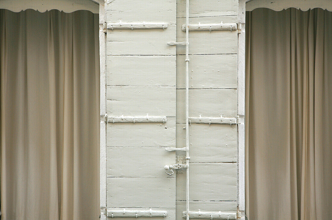 Closed curtains at the windows of a residential house, Arles, France, Europe