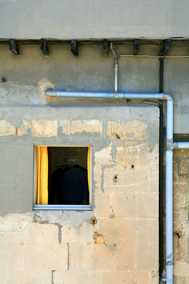 View at a window with yellow curtains at a residential house, Arles, France, Europe