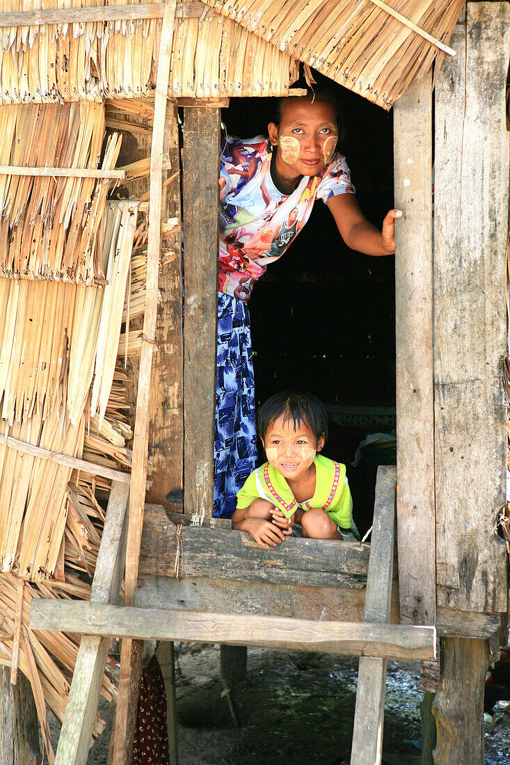 Sea gypsies, Moken woman and child looking out of a hut, Mergui Archipelago, Andaman Sea, Myanmar, Burma, Asia