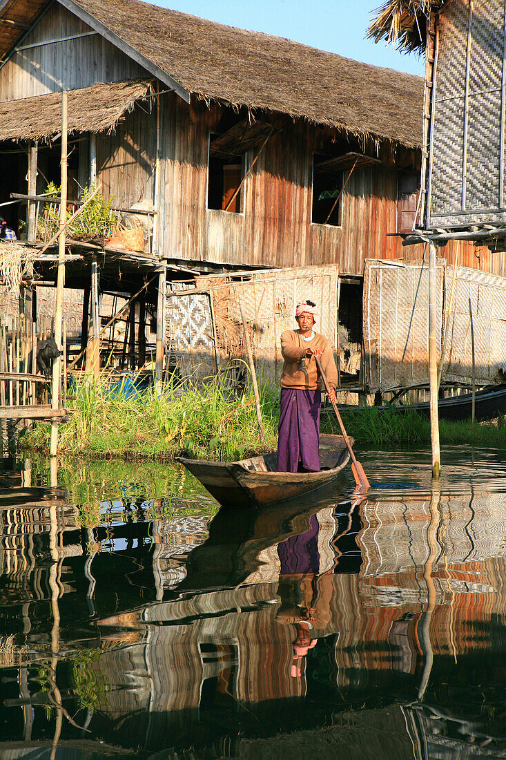 Intha man standing in his boat rowing, Inle Lake, Shan State, Myanmar, Burma, Asia