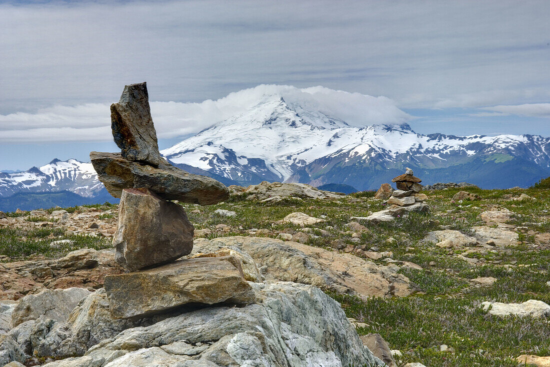 Rock cairn on the slopes of Tomyhoi Mountain Mount Baker Wilderness Washington, Mount Baker 3286 meters 10781 feet is in the distance