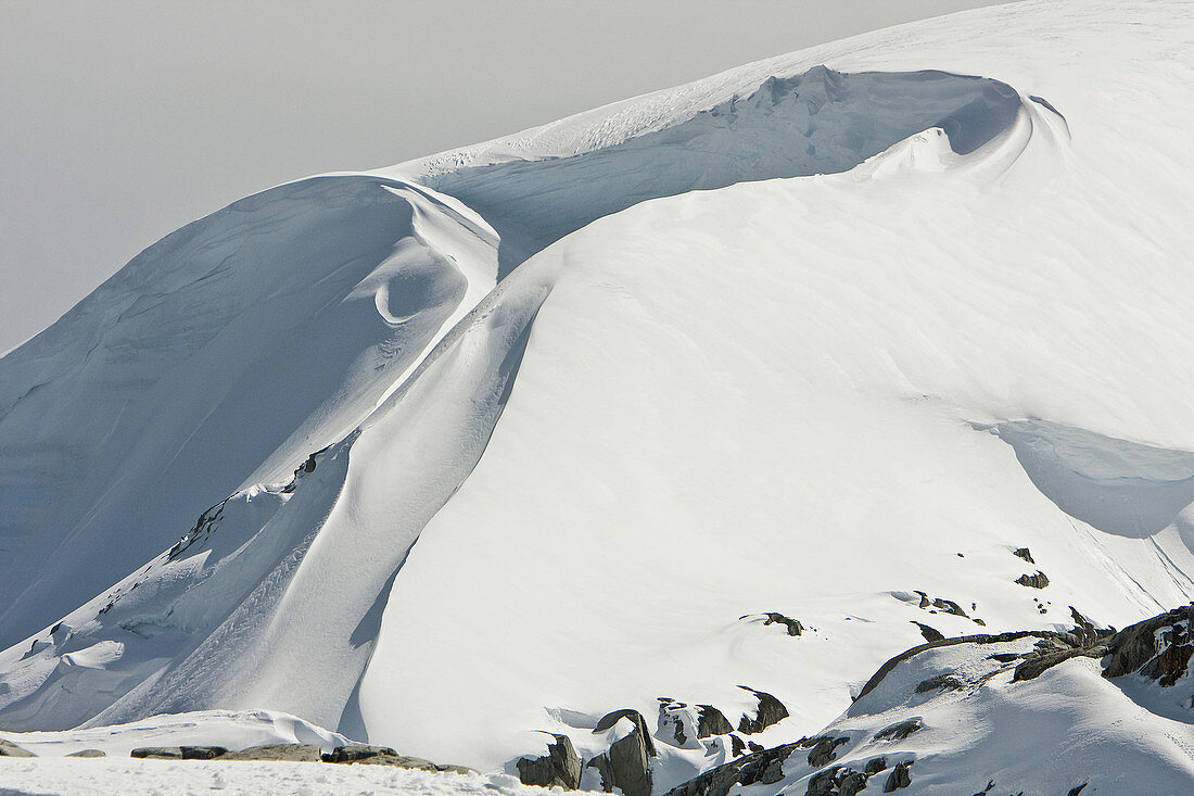 A snow and ice cornice carved by wind and weather on Petermann Island on the western side of the Antarctic Peninsula