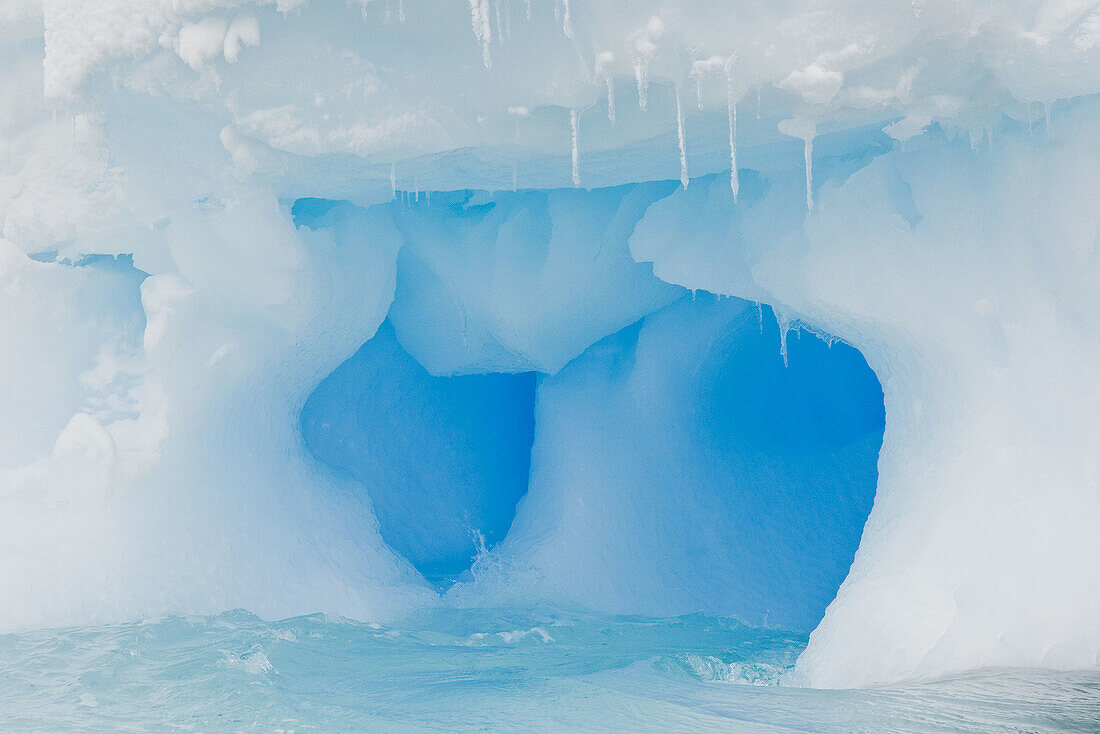 Whimsical ice caves formed by wind and sea in this iceberg detail in and around the Antarctic Peninsula during the summer months  More icebergs are being created as global warming is causing the breakup of major ice shelves and glaciers