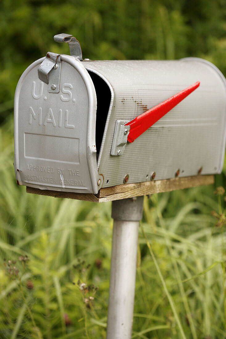 Bent and broken country mail box on a pole