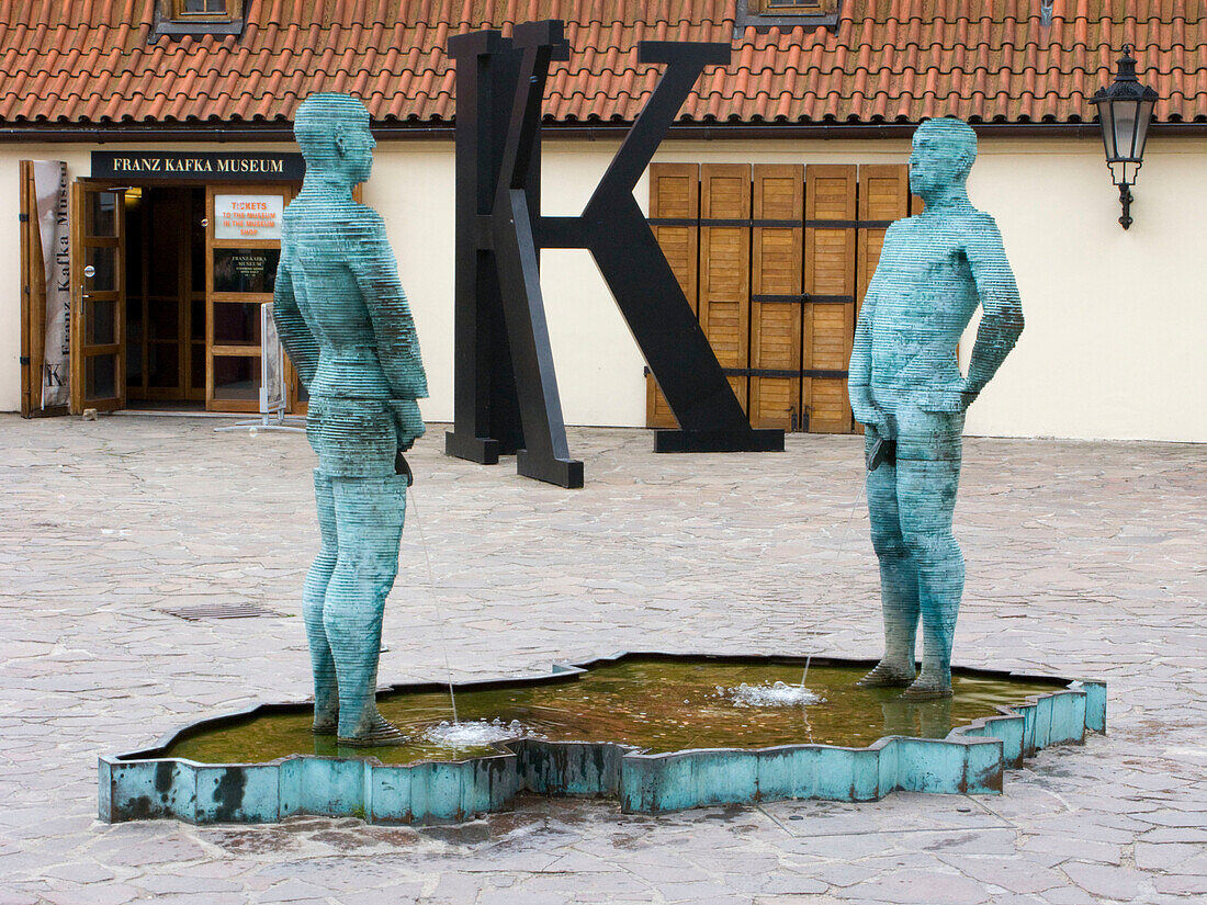 Pissing sculpture david cherny franz kafka museum courtyard mala strana. Prague. Czech Republic.