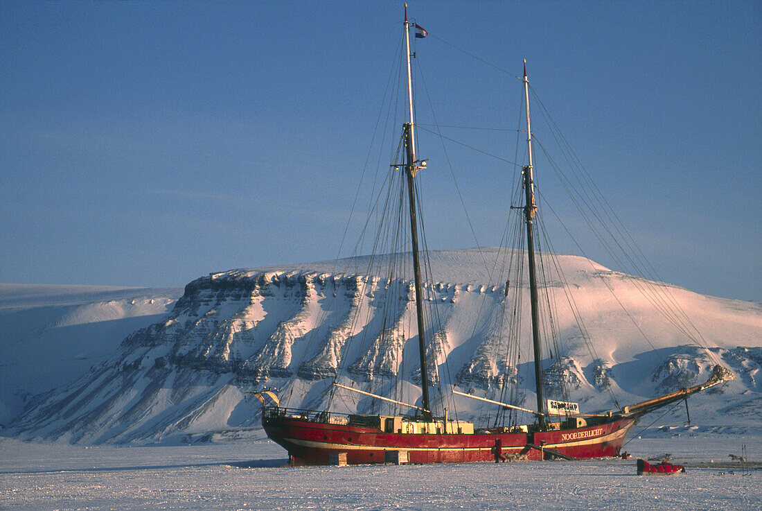 Dutch yacht Nooderlicht frozen in fiord near Longyearbyen Spitsbergen Island Svalbard Norwegian Arctic
