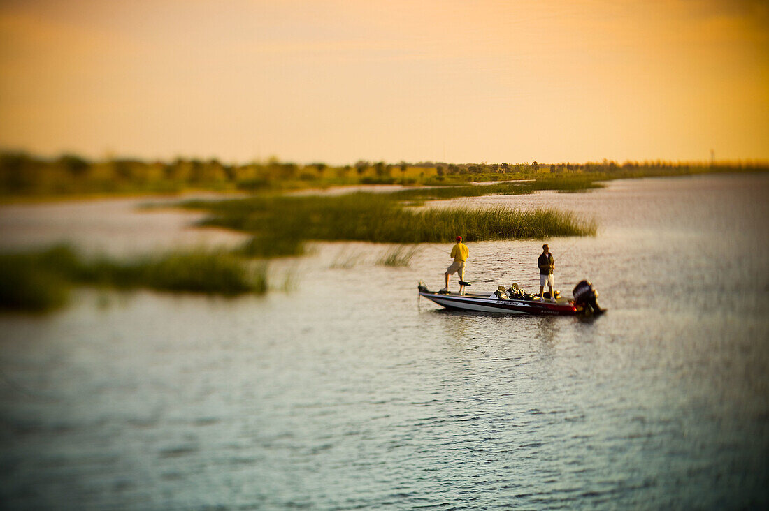 Sunrise Bass fishing on Lake Ochechobee, Florida USA baitcasting for bass from bassboat