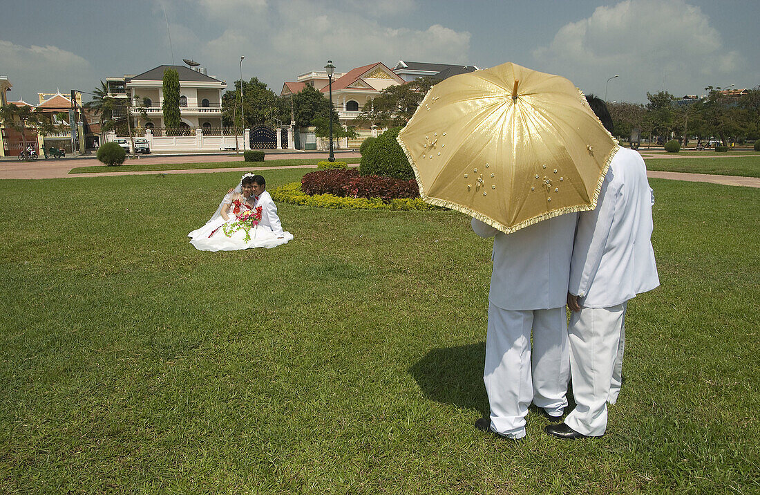 Bride and groom posing for wedding photographs  Phnom Pehn, Cambodia