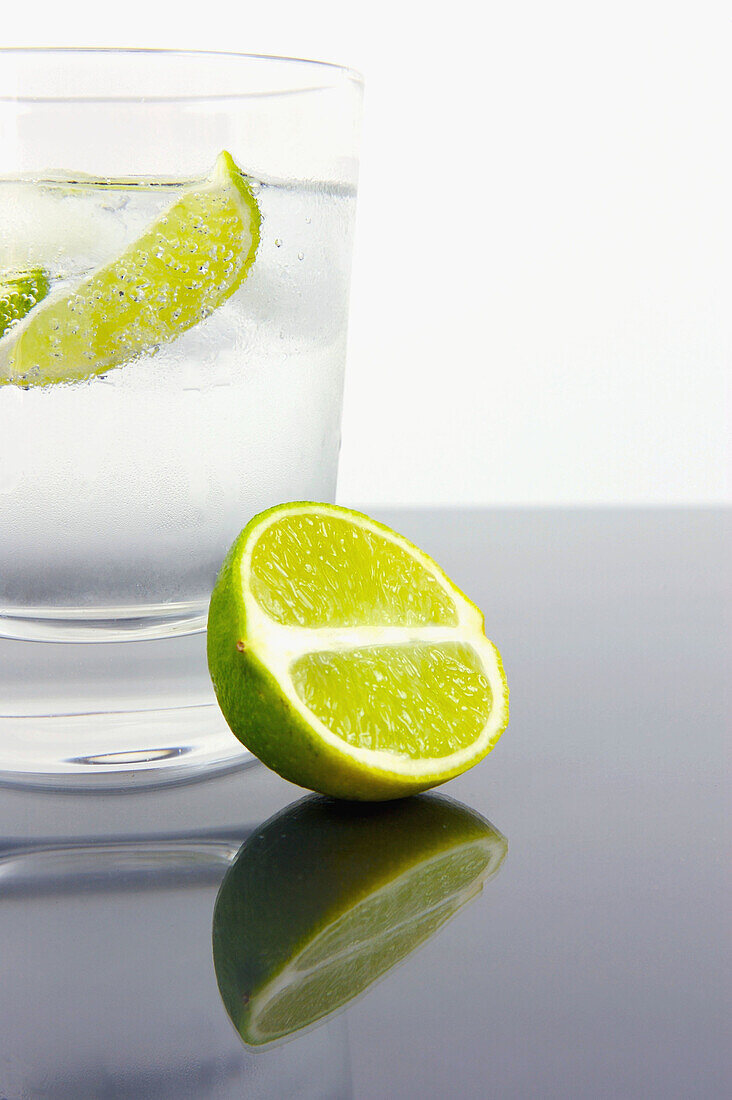 Block, Blocks, Bottle, Bottled, Clean, Clear, Cold, Color, Colour, Drink, Drinking, Eco, Environment, Glass, Green, Ice, Lime, Natural, Planet, Plastic, Quench, Rain, Slice, Spring, Still life, Studio shot, Thirst, Water, Wedge, N90-724170, agefotostock