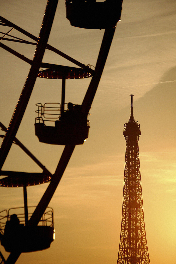 France. Paris. The view of the ferry wheel in Palace de la Concorde with Eiffel Tower in the background after sun set.