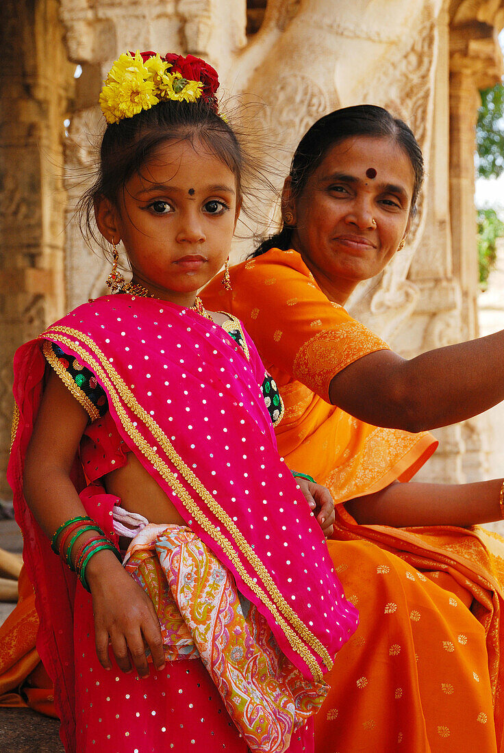 Indian girl with mother at temple