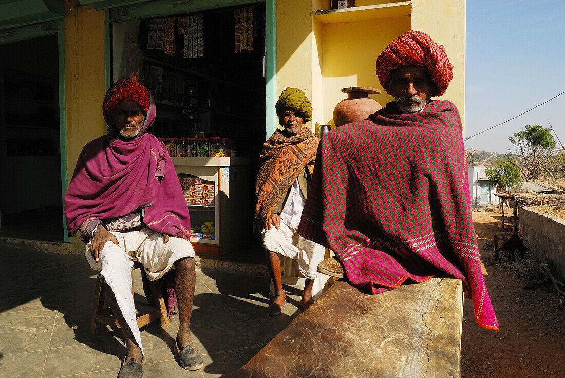 Three Rajasthan men were sitting front of little shop, India