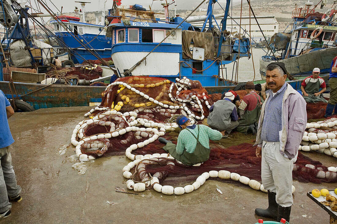 Agadir, Morocco, port, trawler: repairing nets