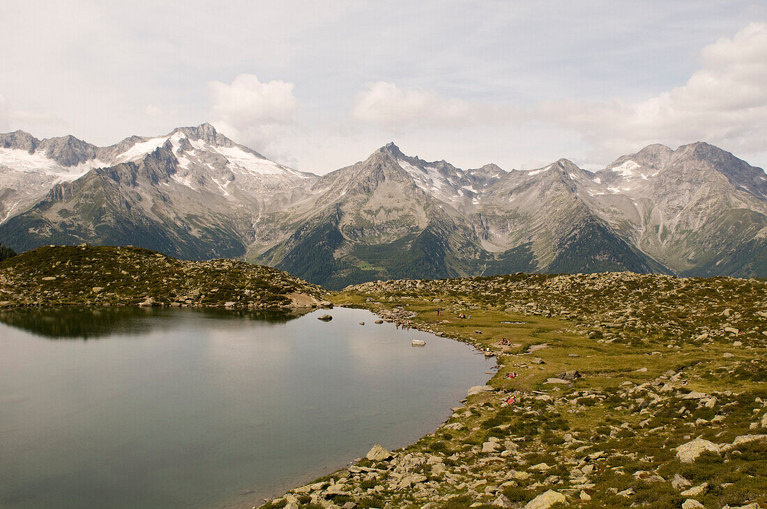 Lake Klaussee in the hiking area of Klausberg, view towards Zillertaler Alps, Tauferer Ahrntal, South Tyrol, Italy
