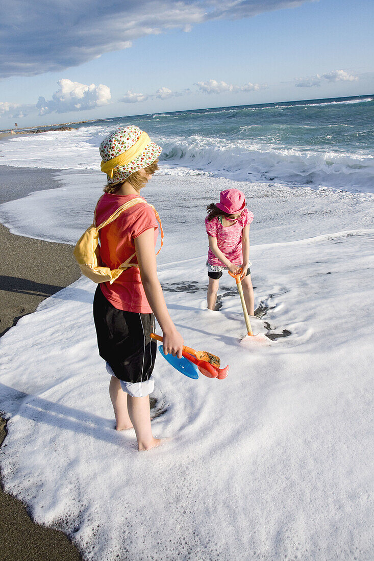 girl children on beach 2 sisters