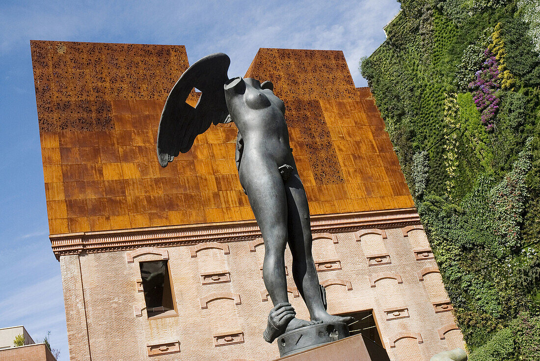 CaixaForum cultural center by Herzog & de Meuron, vertical garden by Patrick Blanc and sculptures by Igor Mitoraj, Madrid. Spain