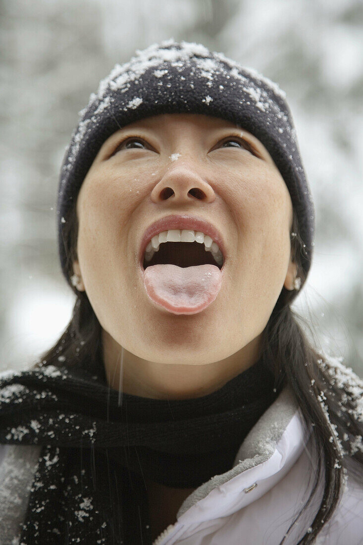 Woman catching snowflake.