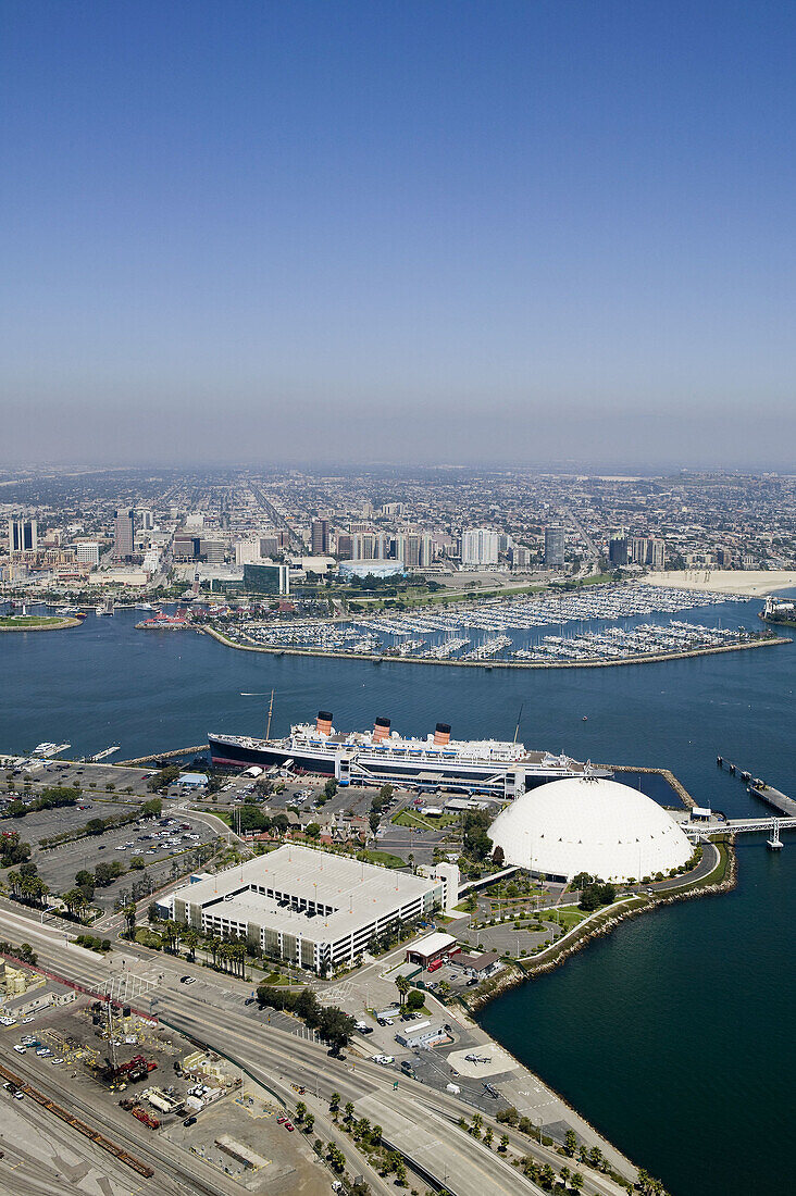 Aerial view of the Queen Mary with the city of Long Beach in the background.