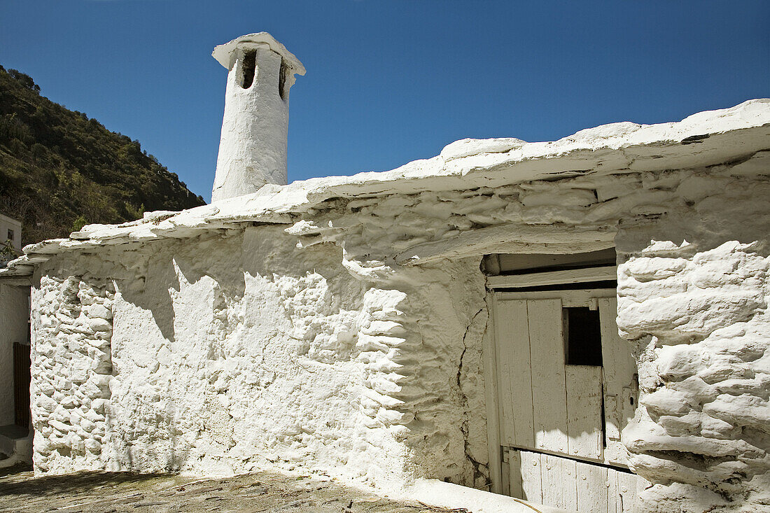 Chimney and white-washed wall, Pampaneira in Barranco del Poqueira, Alpujarras. Granada province, Andalucia, Spain