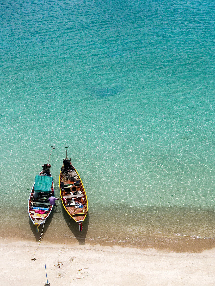 two longtail boats in beautiful Mango Bay on Koh Tao Island in Thailand