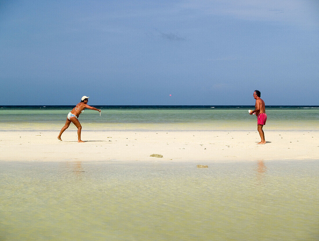 couple playing paddleball on the beach on Ko Tao Island in Thailand
