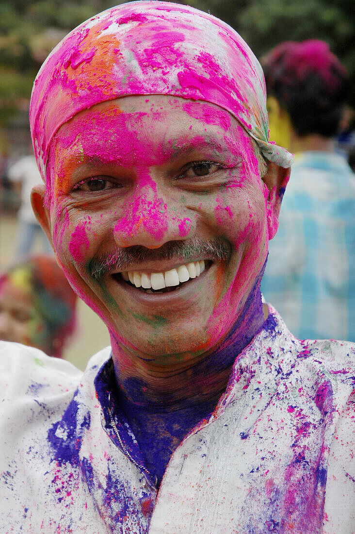 Panjim Goa, India, man with colored powder on the face during the Holi feast