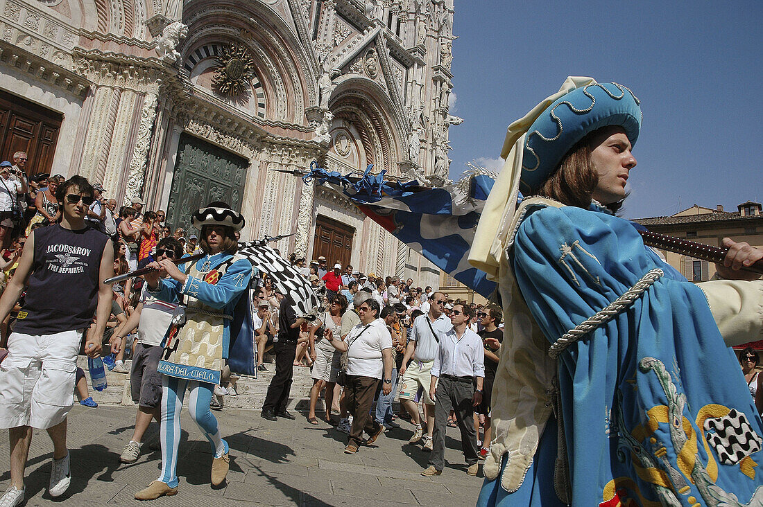 Siena Italy, flag-weavers of the Contrada dellOnda in front of the Dome during the Palio