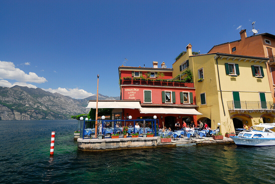 Restaurant at lakeshore, Malcesine, lake Garda, Veneto, Italy