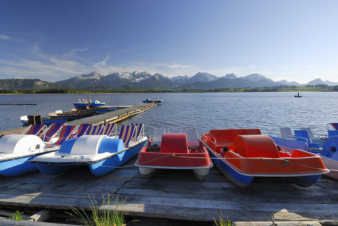 pedal boats at lake Hopfensee with Tannheim range in background, Allgaeu, Swabia, Bavaria, Germany