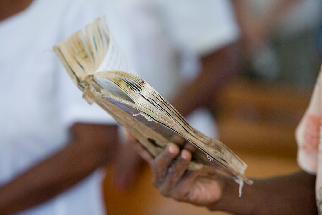 Woman holding hymnbook at church service, Naidi, Vanua Levu, Fiji Islands, South Pacific, Oceania