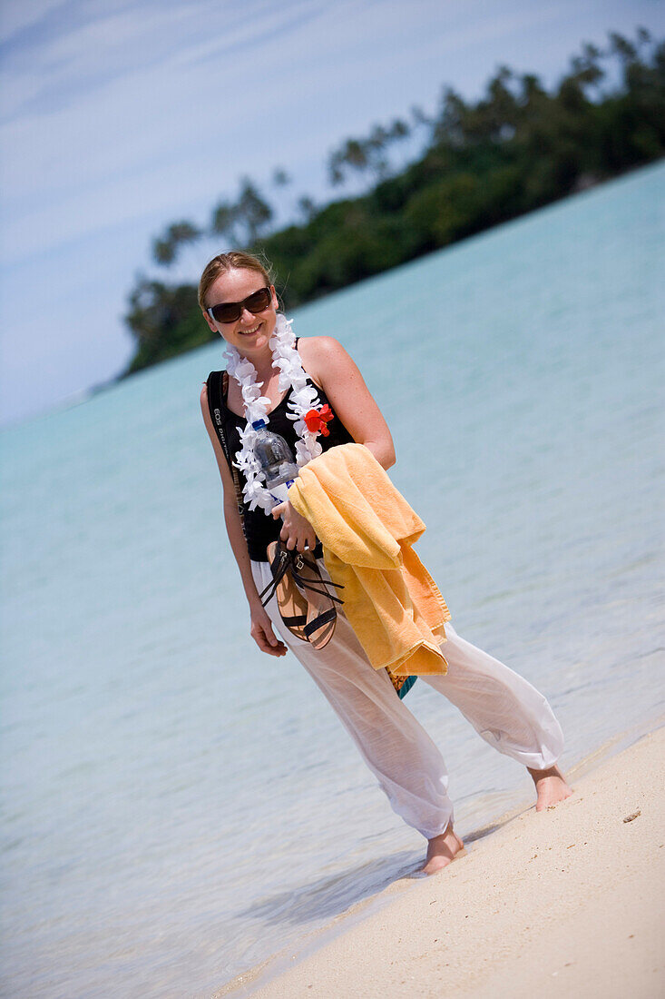 Young woman strolling along Muri Beach, Rarotonga, Cook Islands, Oceania