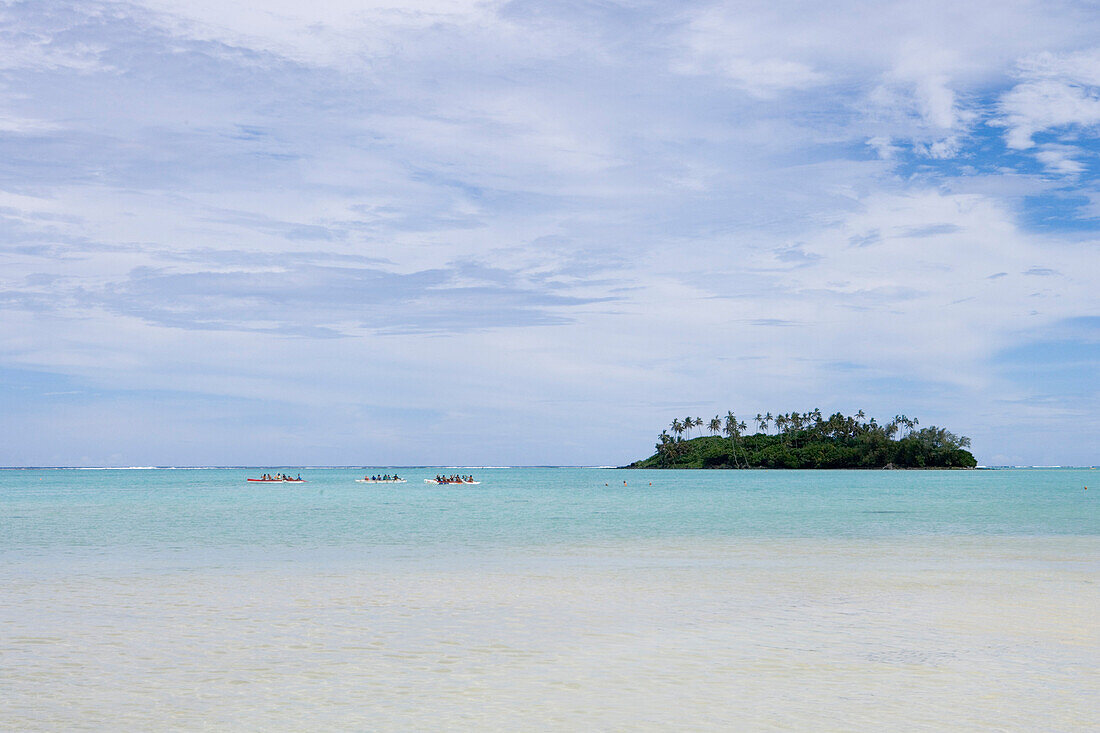 View at distant canoes and Taakoka Motu at Muri Lagoon, Rarotonga, Cook Islands, South Pacific, Oceania