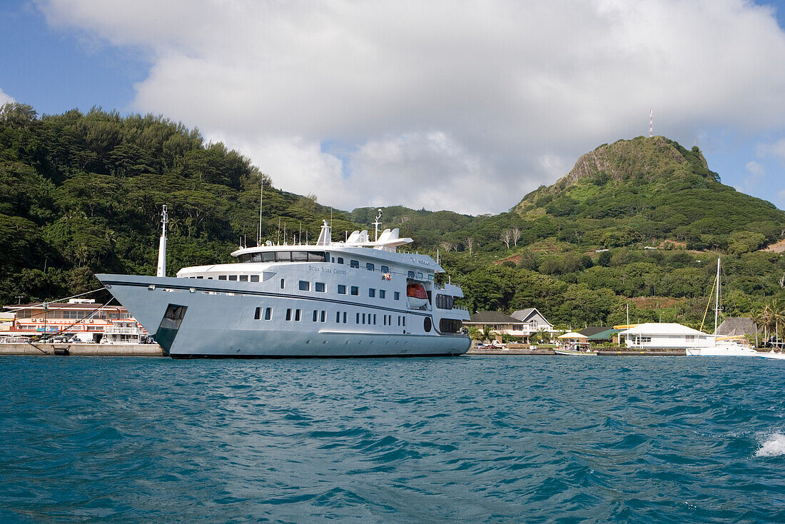 Cruisehip Tu Moana at the pier under white clouds, Raiatea, Society Islands, French Polynesia, South Pacific, Oceania