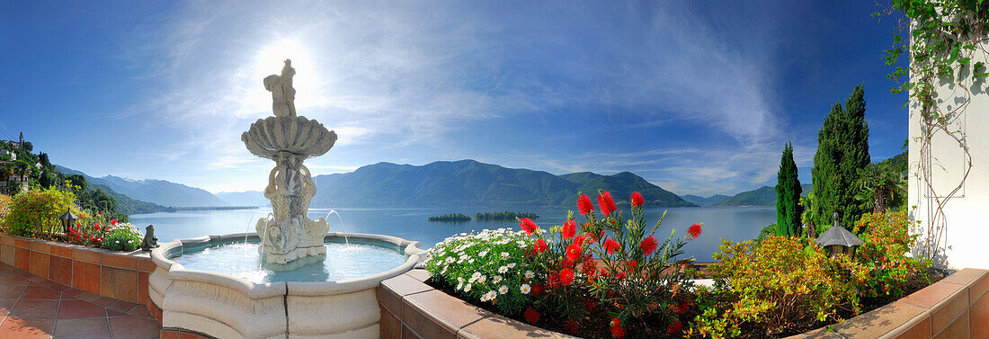 Panorama of lake Maggiore with isle of Brissago, Isole di Brissago, and Monte Gambarogno, fountain and flowers in the foreground, Ronco sopra Ascona, lake Maggiore, Lago Maggiore, Ticino, Switzerland