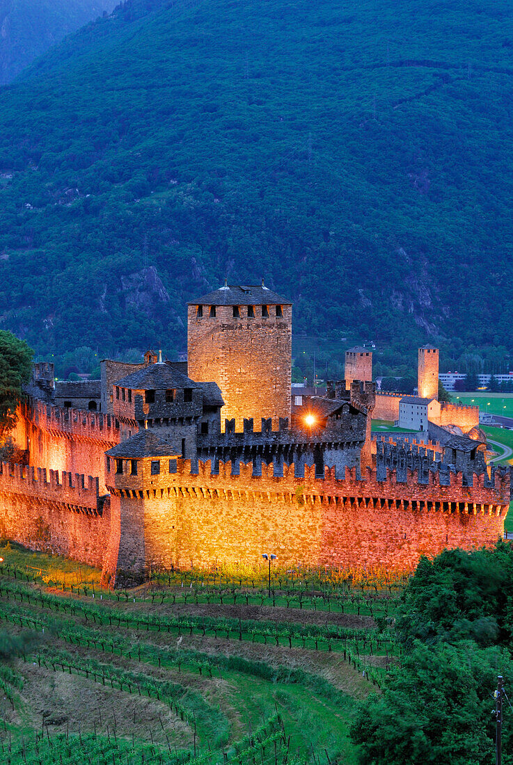 Illuminated castle Castello di Montebello and castle Castelgrande in background in UNESCO World Heritage Site Bellinzona, Bellinzona, Ticino, Switzerland