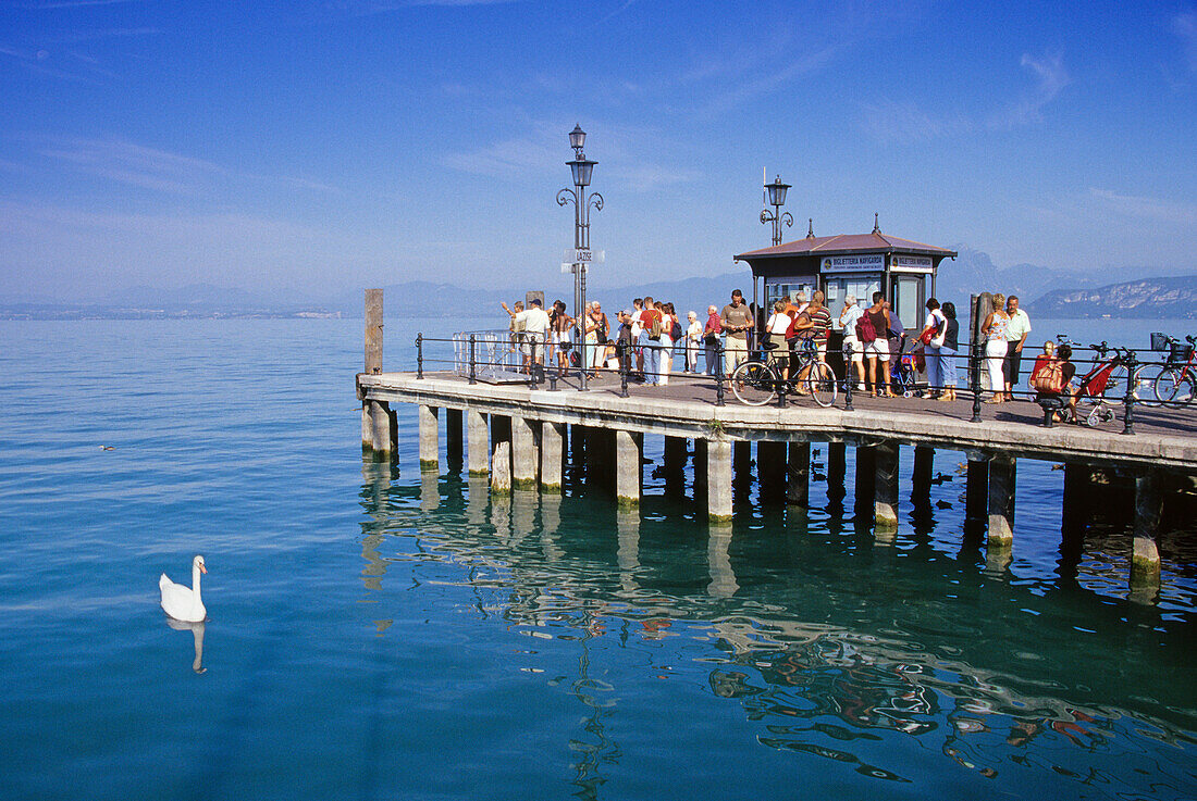 People standing on the landing stage waiting, Lazise, Lake Garda, Veneto, Italy, Europe