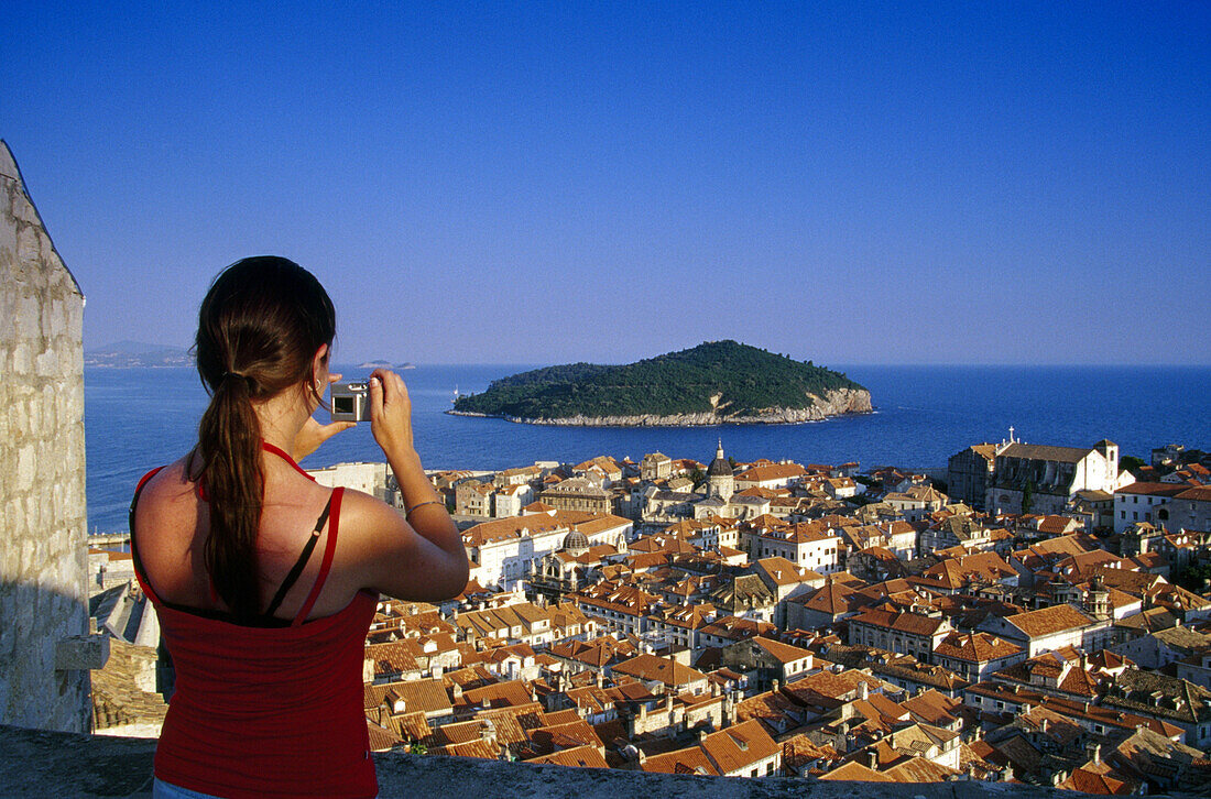 Young woman taking a picture of the Old Town of Dubrovnik, Croatian Adriatic Sea, Dalmatia, Croatia, Europe