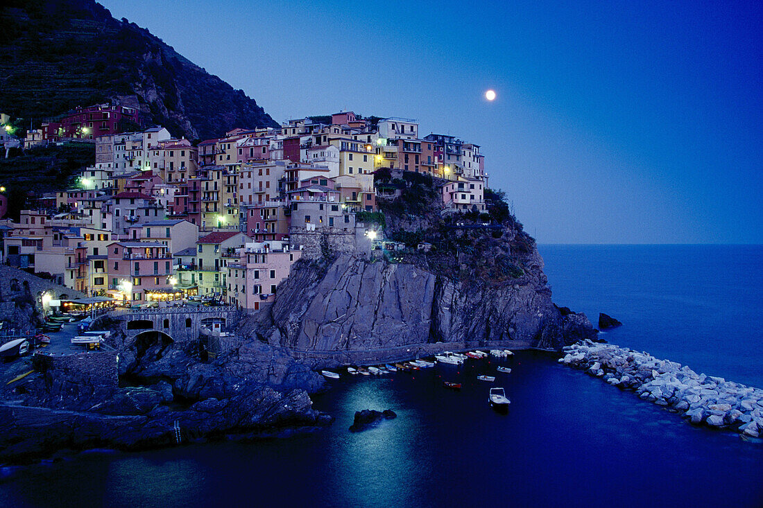 Full moon above the rocky coast at Manarola, Cinque Terre, Liguria, Italian Riviera, Italy, Europe