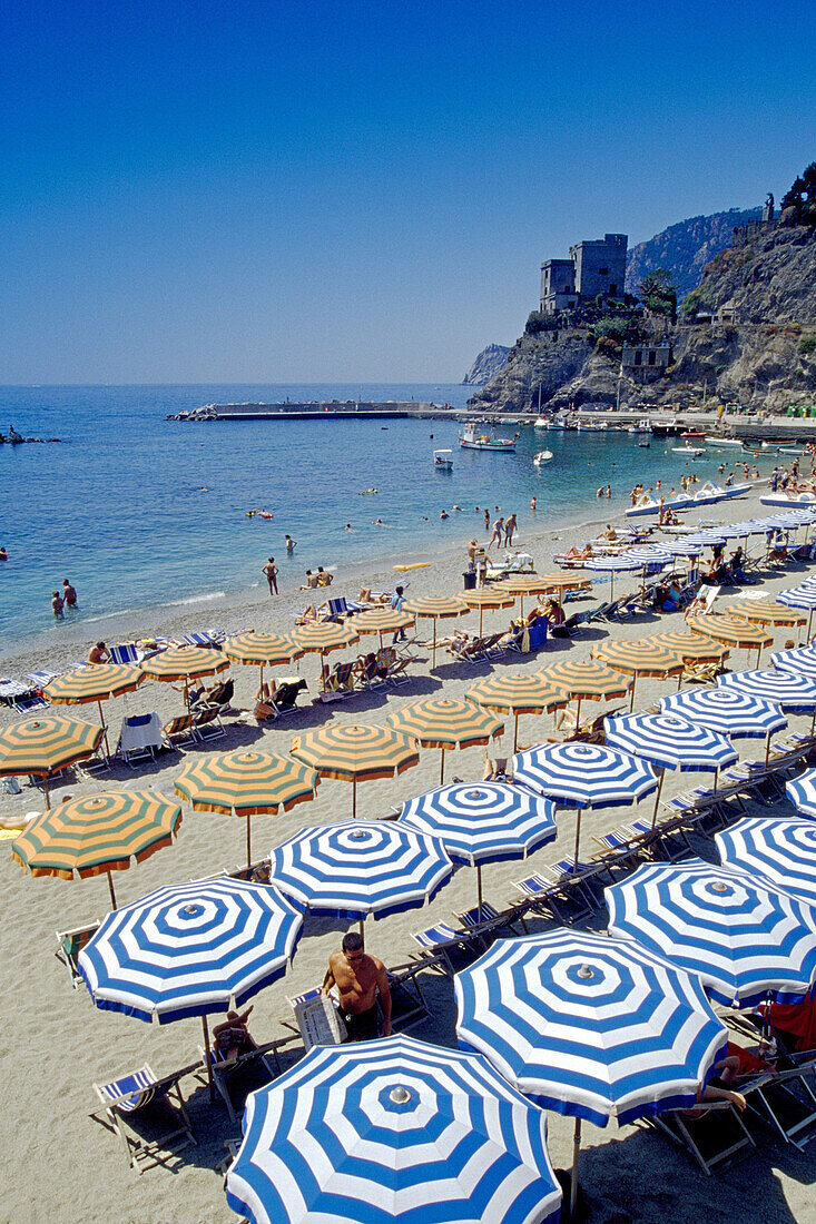 People and sunshades on the beach, medieval tower, Monterosso al Mare, Cinque Terre, Liguria, Italian Riviera, Italy, Europe