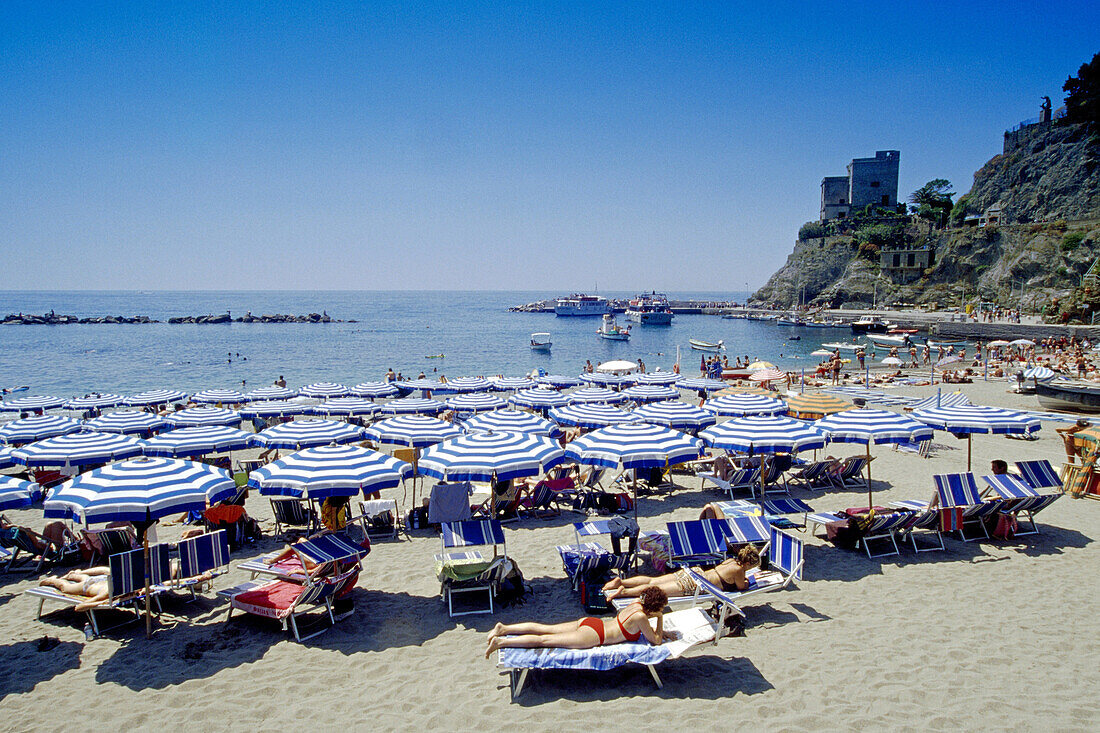 People and sunshades on the beach, medieval tower, Monterosso al Mare, Cinque Terre, Liguria, Italian Riviera, Italy, Europe