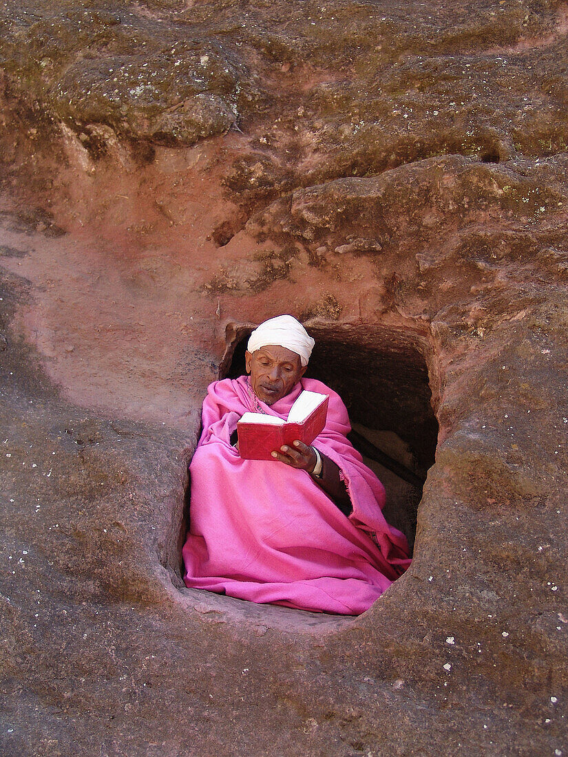 ETHIOPIA  Monk in pink, Abba Gebra Kidan staying in the caves near the churches of Lalibela