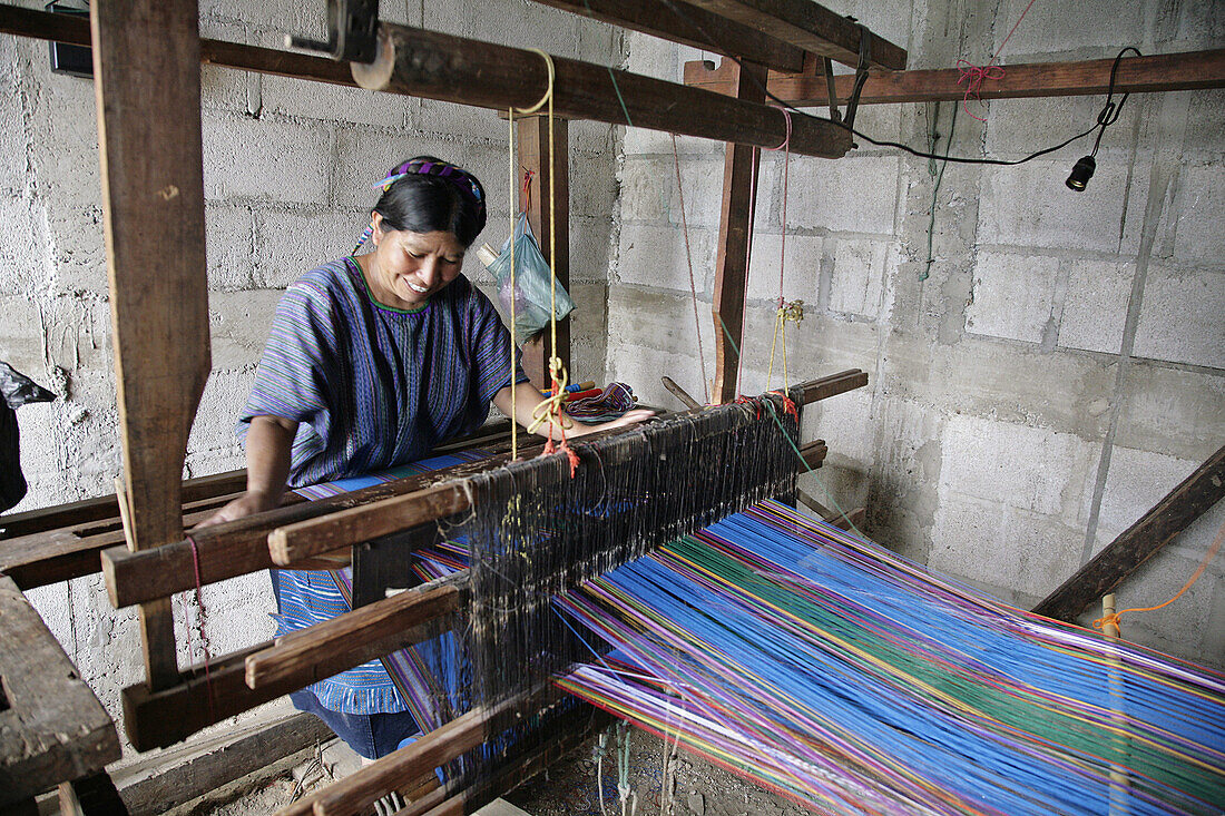 GUATEMALA  Petrona Perez Choco weaving by hand on loom, Santa Catarina Palopo, on Lake Atitlan