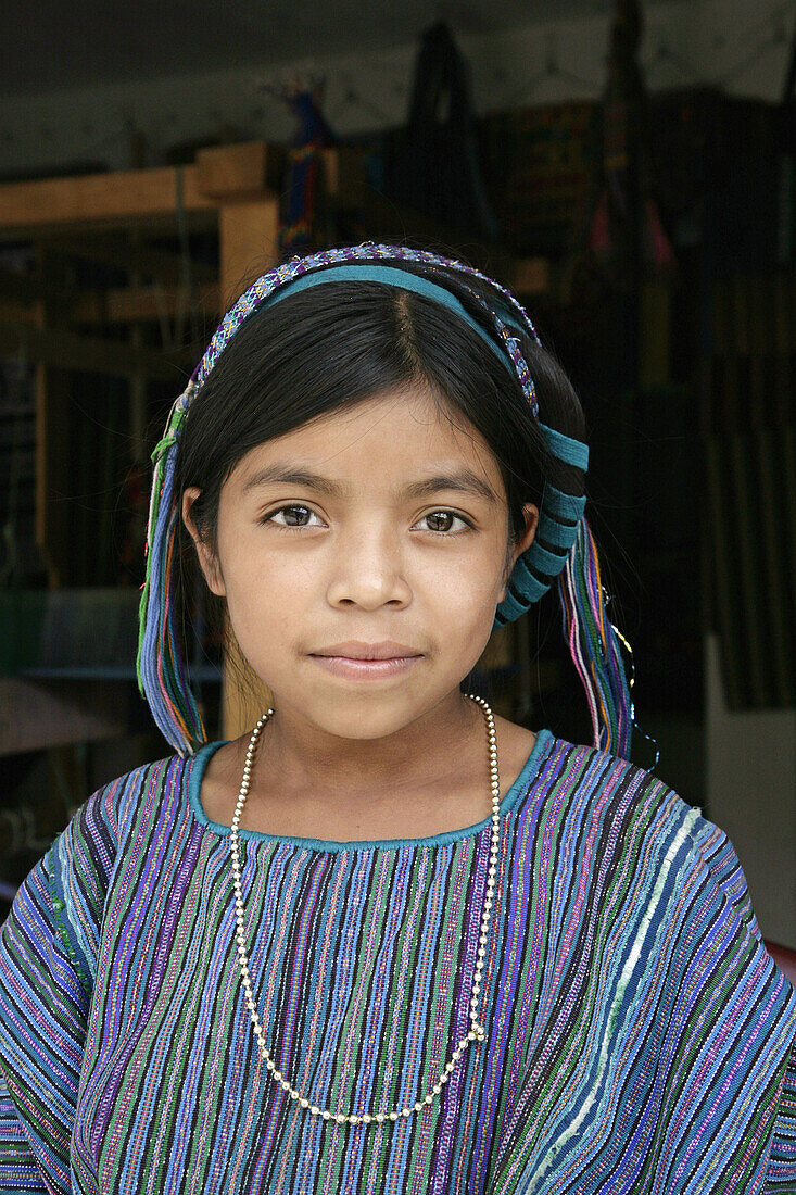 GUATEMALA  Girl in traditional handwoven clothes, Santa Catarina Palopo, on Lake Atitlan