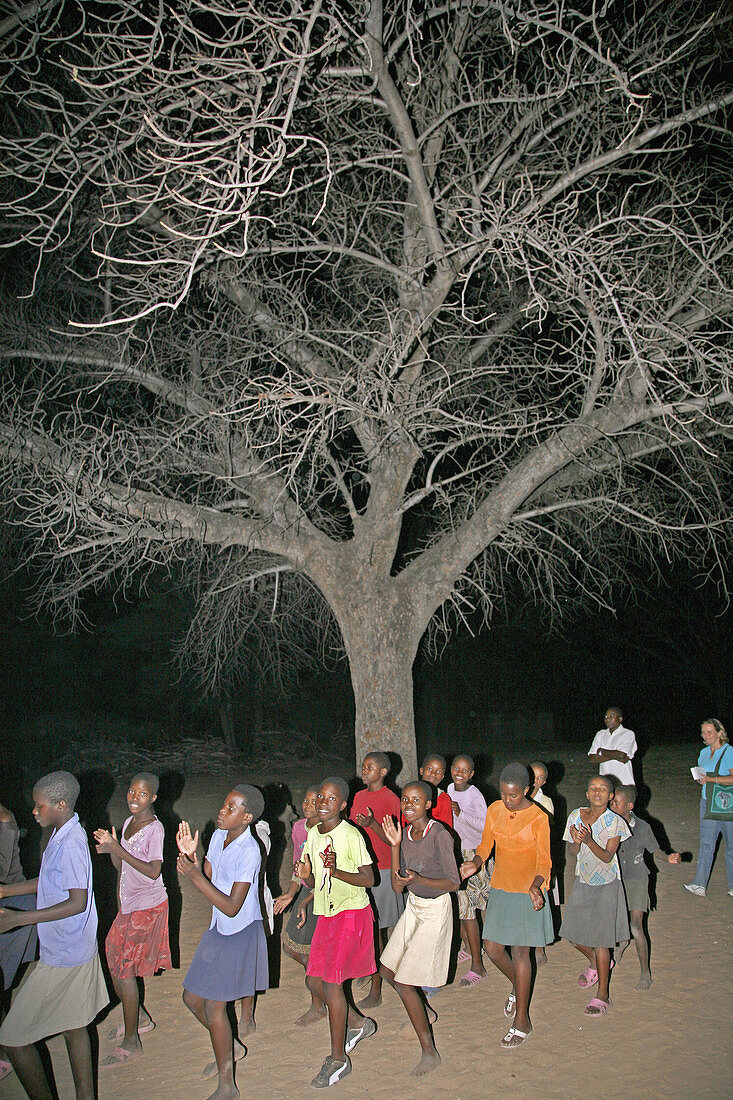 NAMIBIA  Girls dancing under a tree, Nyangana, a small village and mission station in the north of the country on the Angolan border
