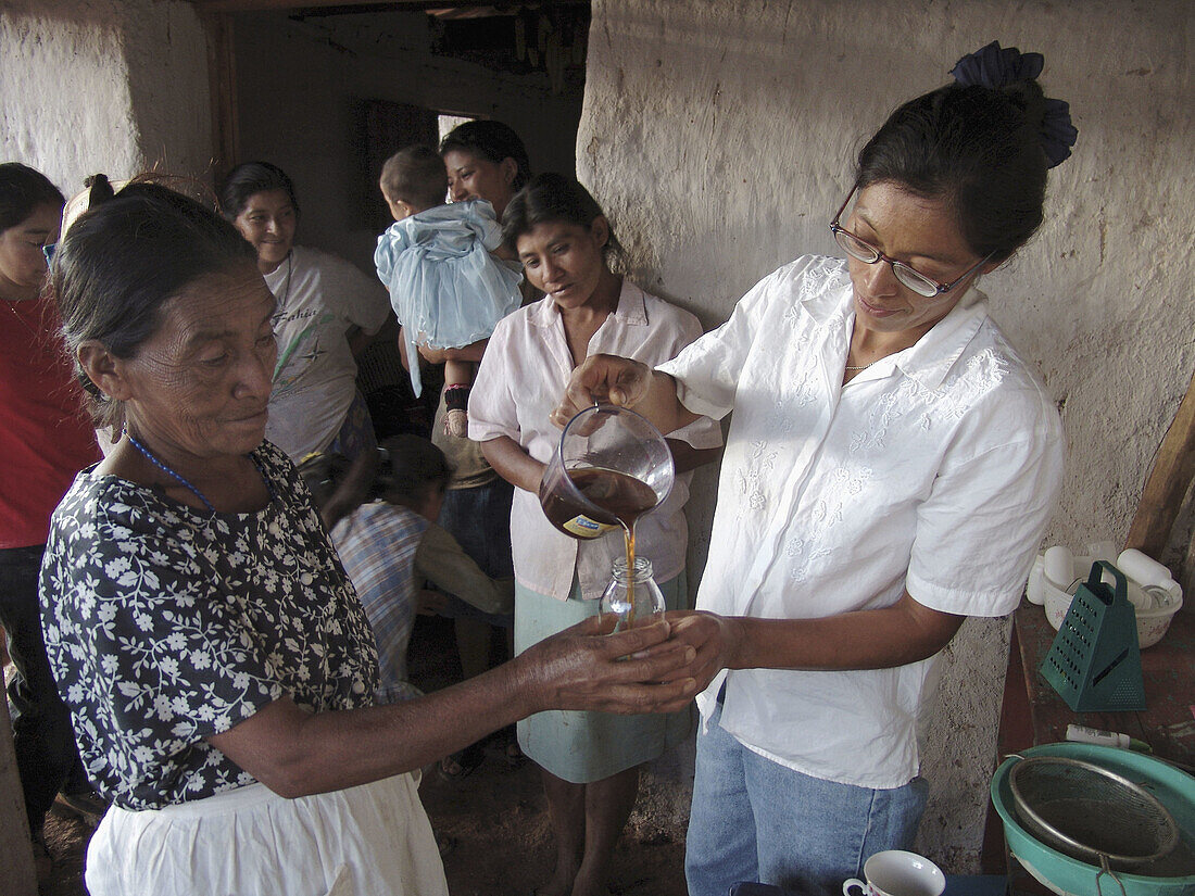 HONDURAS  Woman teaching a womens group to make shampoo from natural organic materials, Marcala