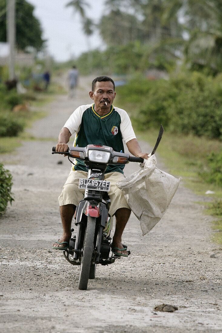 INDONESIA  Transport by motor-cycle, Meulaboh, Aceh, two years after the Tsunami