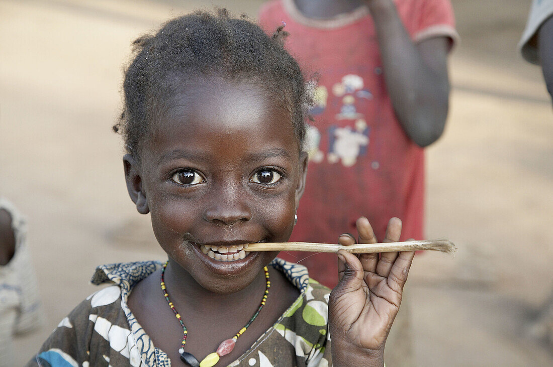 SOUTH SUDAN  Girl cleaning her teeth with a stick, Yei