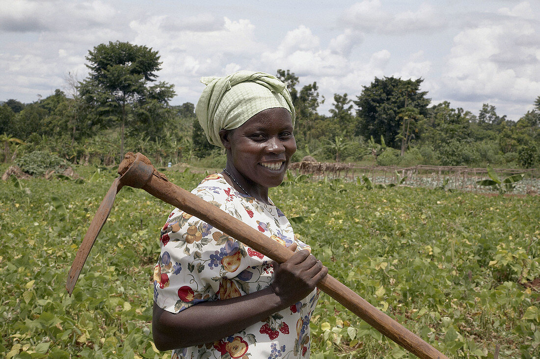 UGANDA  Nejjemba Teopista, farmer of Kayunga and farmers group animator, holding her hoe after working in a communal garden at Kangulumira where food is grown to feed the poor and sick  Caritas Uganda project