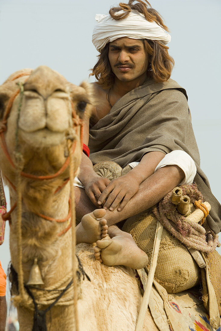 Camel rider & holy man at Kumbh Mela festival. Allahabad, Uttar Pradesh, India